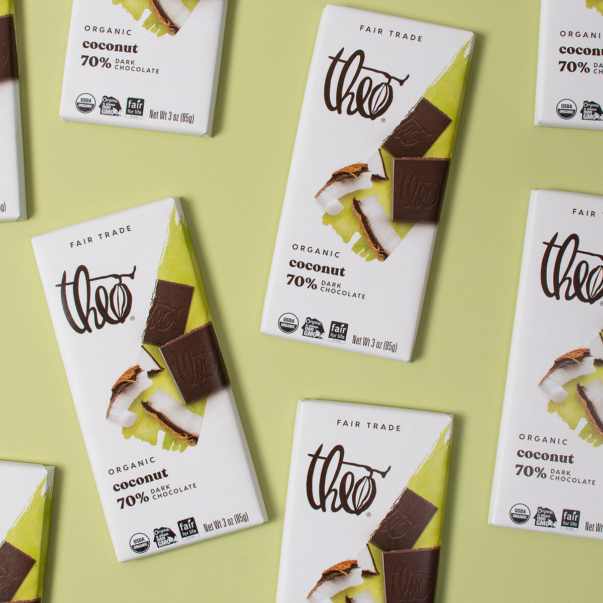 Multiple boxes of Theo Organic Coconut 70% Dark Chocolate on a light green background