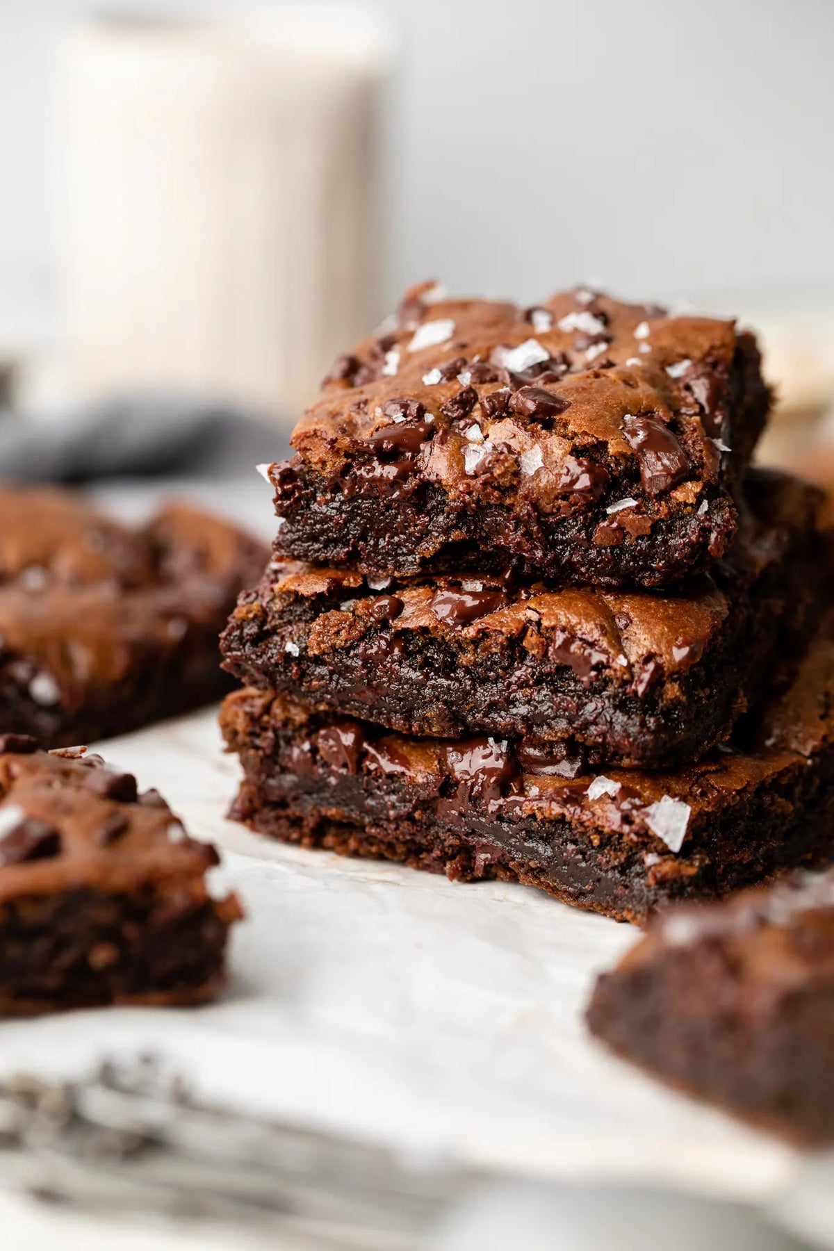 Stack of brownies on a marble surface with blurred background