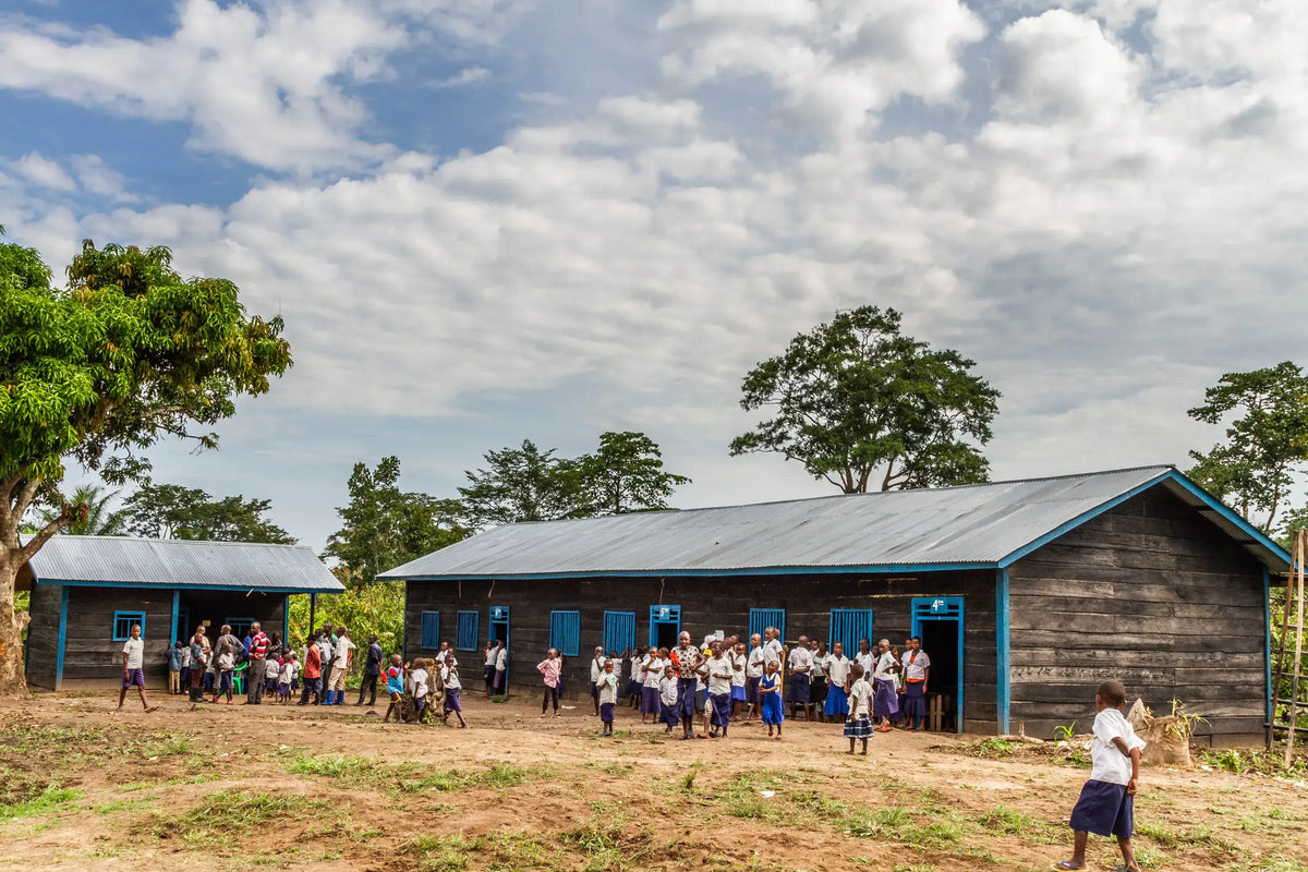 School building with children outside on a sunny day